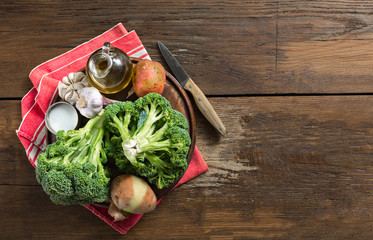 Poster - Raw ingredients for cooking cream broccoli soup on a wooden background