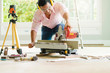 © whyframeshot - smart indian contractor hand use sawing machine wood work house renovation background home improvement ideas concept