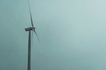 Wall Mural - Windturbine generator at dusk night. Blue sky in the background