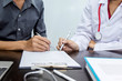 © amnaj - Female doctor who advise patients in medical office.