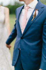 Wall Mural - Groom holding hands with bride, groom leading the way, walking together