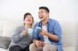 © chayathon2000 - Asian senior grand mother and son drinking coffee and talking happy and smile face in living room