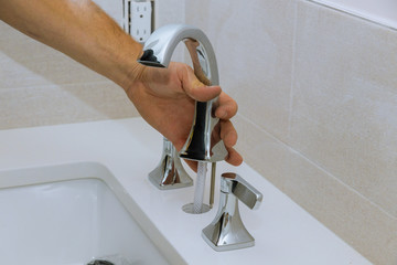 Canvas Print - Plumber installing water faucet in the bathroom