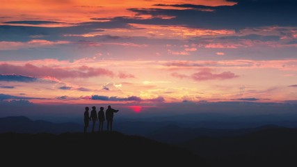 Wall Mural - the four friends standing on a mountain against the sunrise. time lapse