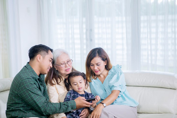 Poster - Little girl watching television with her family