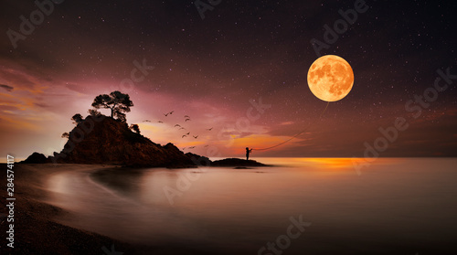Child catches the moon with a rope Poster Mural XXL