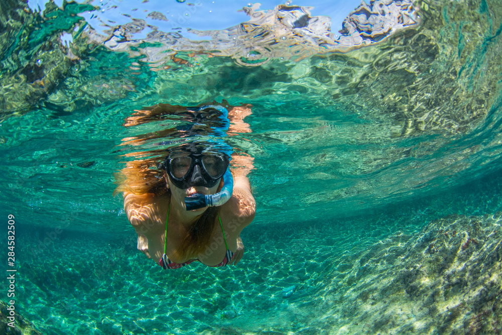 Woman snorkeling in the sea at Tenerife Canary Islands Spain - obrazy, fototapety, plakaty 
