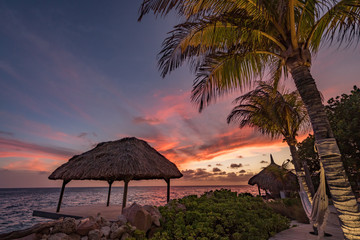 Wall Mural - Sunset over the sea from a house and swimming pool