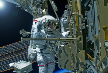 Wall Mural - astronaut on a spaceship doing research. elements of this image were furnished by nasa