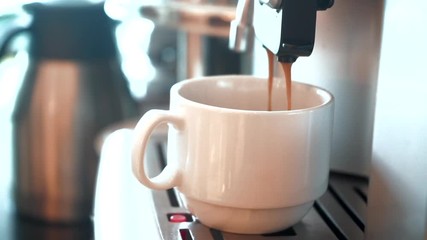 Wall Mural - Coffee poured into a cup of coffee machine