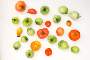 Wall Mural - Summer harvest of vegetables concept. Set of green and red tomatoes.