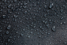Dark Gray Waterproof Hydrophobic Cloth Closeup With Water Drops Selective Focus Background