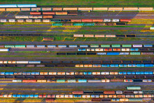 Aerial View Of Rail Sorting Freight Station With Railway Cars, With Many Rail Tracks Railroad. Heavy Industry Landscape On Evening Sunset Light.