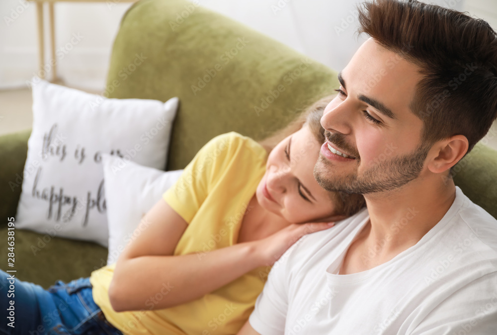 Happy couple watching TV at home