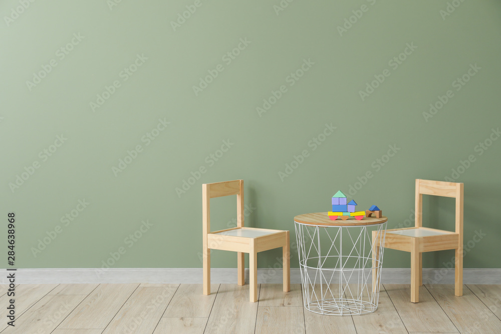 Table and chairs near wall in modern children's room