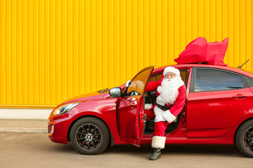 Wall Mural - Santa Claus getting out of car outdoors