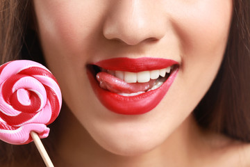 Sticker - Beautiful young woman with bright lipstick and lollipop, closeup