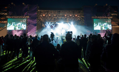 crowd of people at concert or show, night scene