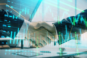 Multi exposure of financial graph on office background with two businessmen handshake. Concept of success in business