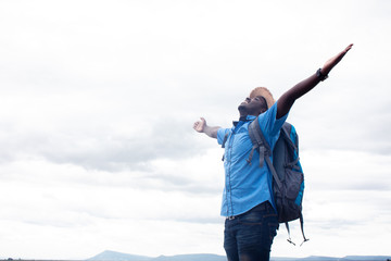 Wall Mural - Freedom African tourist  traveler man with backpack on view of mountain background