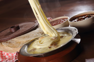 Melted cheese with mushrooms, tortillas and hot sauce.