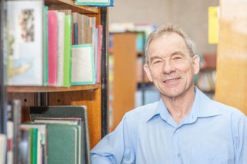 Smiling senior man in a library