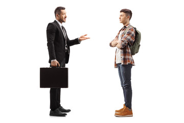 Wall Mural - Businessman with a briefcase talking to a male student