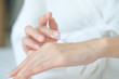 © BoszyArtis - Woman applying moisturizing cream/lotion on hands, beauty concept.