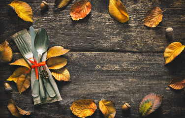 Wall Mural - Autumn background with vintage place setting on old wooden table