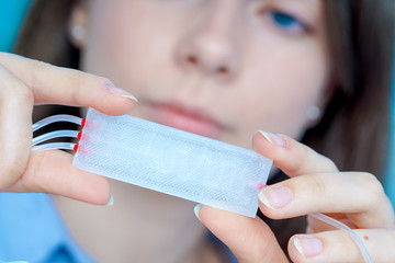 Canvas Print - Girl holding polymers Bio-MEMS biomedical microelectromechanical systems / LOC lab-on-a-chip device (concept design)