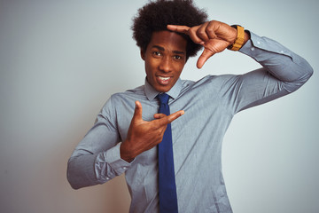 American business man with afro hair wearing shirt and tie over isolated white background smiling making frame with hands and fingers with happy face. Creativity and photography concept.