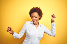 African American Business Woman Over Isolated Yellow Background Dancing Happy And Cheerful, Smiling Moving Casual And Confident Listening To Music