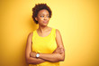 © Krakenimages.com - Beauitul african american woman wearing summer t-shirt over isolated yellow background smiling looking to the side and staring away thinking.