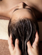 © Valua Vitaly - Cosmetologist massaging hair on the head of the woman. Spa treatments.