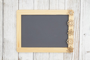 Wall Mural - Blank chalkboard with flowers on weathered whitewash textured wood background