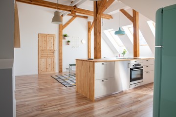 Modern attic white bright kitchen in the loft apartment