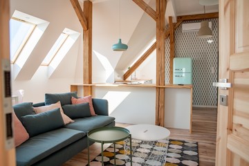 Bright attic kitchen in apartment. Kitchen connected with living room