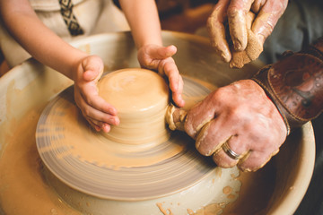 Professional potter making bowl in pottery workshop, studio.