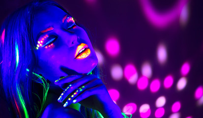 Wall Mural - Fashion disco woman. Dancing model in neon light, portrait of beauty girl with fluorescent makeup. Art design