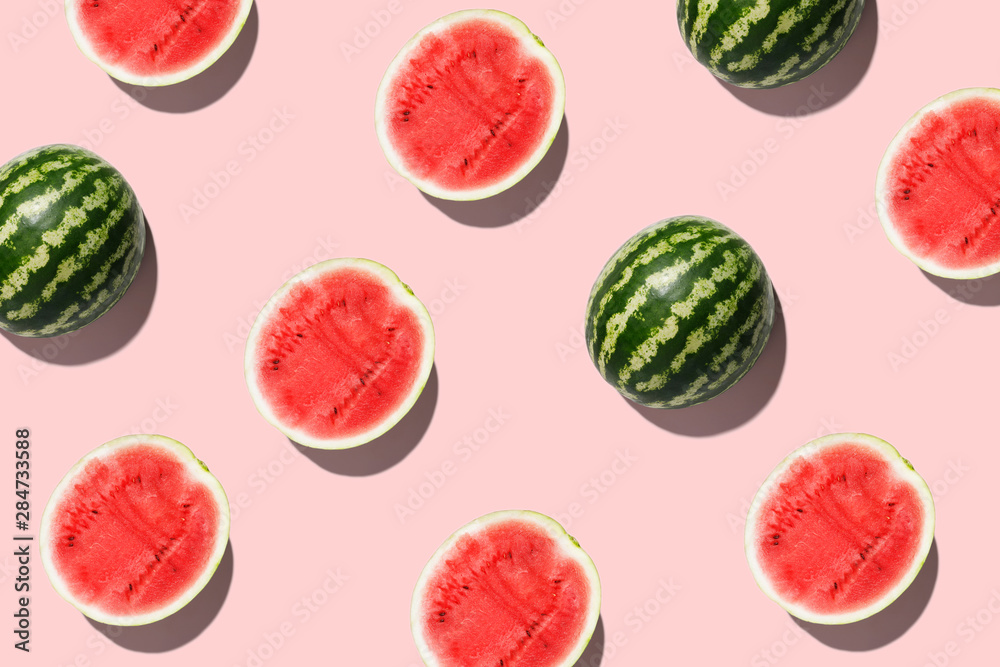 Pattern with ripe watermelon on pink background. Top View. Copy Space. Pop art design, creative summer concept. Half of watermelon in minimal flat lay style - obrazy, fototapety, plakaty 