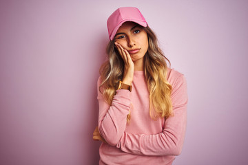 Canvas Print - Young beautiful woman wearing cap over pink isolated background thinking looking tired and bored with depression problems with crossed arms.