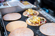 © gesrey - Fast food on the street. A delicious dish of meat and sauce with potatoes and vegetables on a bread cake.