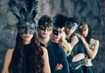 Wall Mural - Group of people in masquerade carnival mask posing in studio