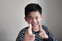 Smiling Asian Preteen Teenage Boy Pointing Finger Gun Gesture, Fun Cheeky Happy Youth Portrait