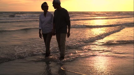 Wall Mural - Asian couple senior elder retire resting relax holding hand walking at sunset beach honeymoon family together happiness people lifestyle, Slow motion footage