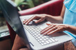 © undrey - Close-up shot of female hands typing on laptop keyboard