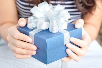 hand of man holds a red gift box to hand woman. he is preparing to give her lover.