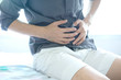 © Photo Sesaon - People have abdominal pain. Take a hand from the belly diarrhea.Health concept