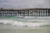 Fototapeta  - Surfers at Pacific Beach Pier California