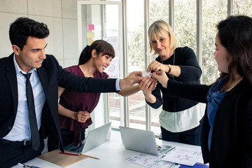 These business people holding jigsaw sincere together as a team.